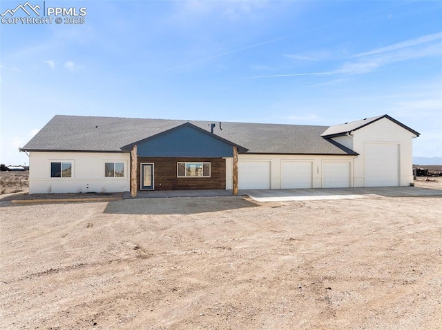 ranch-style home featuring a garage and driveway