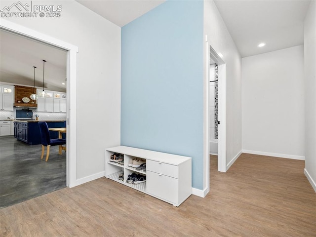 hall featuring recessed lighting, wood finished floors, and baseboards