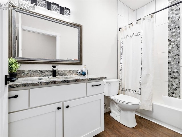 bathroom featuring toilet, wood finished floors, vanity, and shower / bath combination with curtain