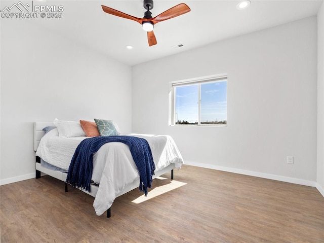 bedroom featuring recessed lighting, wood finished floors, visible vents, and baseboards