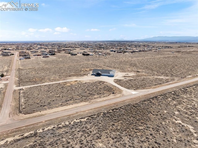 aerial view with a mountain view, a rural view, and a desert view