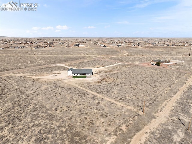 birds eye view of property featuring a rural view and a desert view