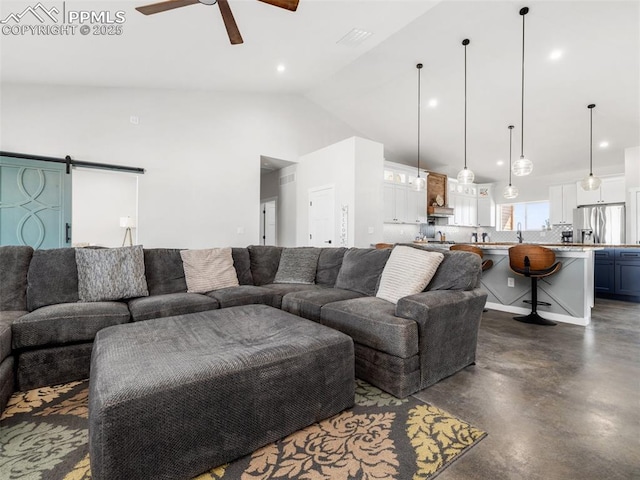 living room with high vaulted ceiling, finished concrete flooring, recessed lighting, a barn door, and ceiling fan