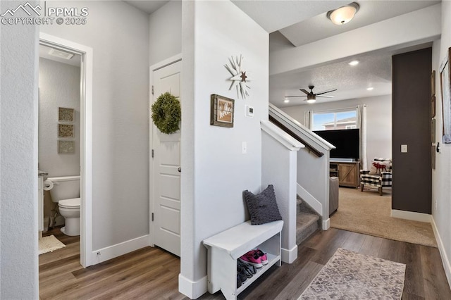 entrance foyer with a ceiling fan, wood finished floors, recessed lighting, baseboards, and stairs