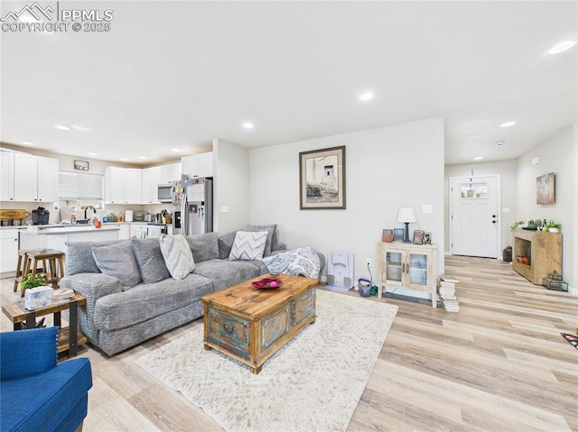 living room with recessed lighting and light wood finished floors