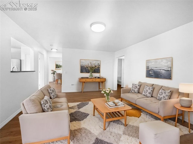 living area featuring wood finished floors and baseboards