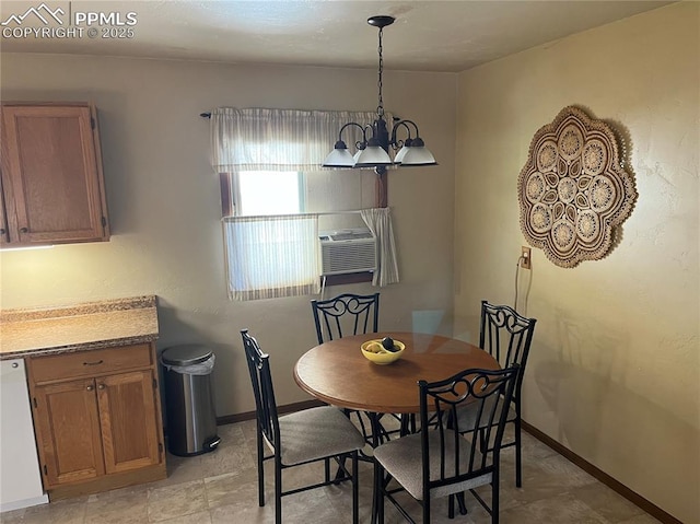 dining area featuring cooling unit, baseboards, and a chandelier