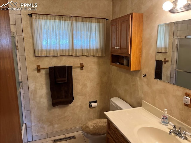 bathroom with visible vents, toilet, a shower with door, tile patterned flooring, and vanity