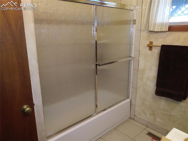 full bath featuring tile patterned floors, visible vents, and enclosed tub / shower combo