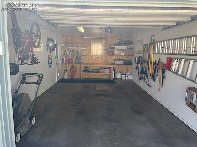 garage with a workshop area and a garage door opener