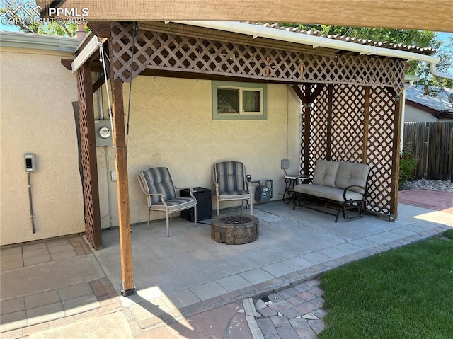 view of patio / terrace with fence and a fire pit