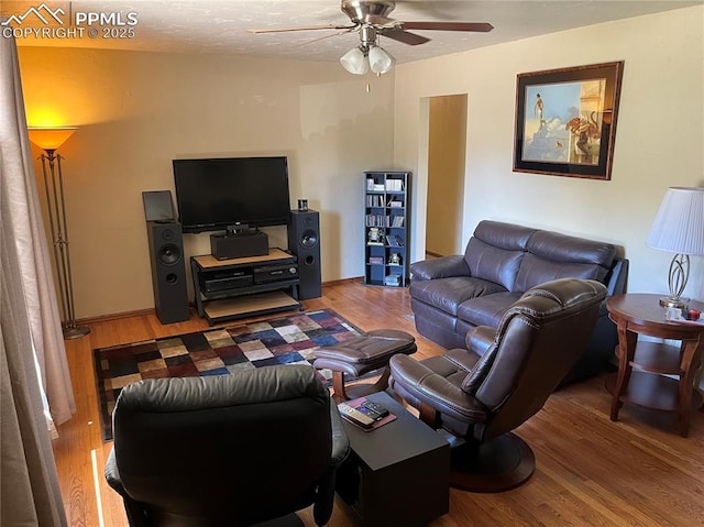 living area with light wood-style flooring and a ceiling fan