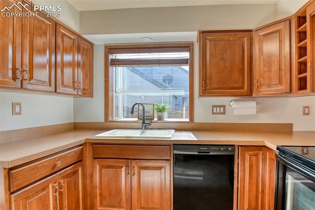 kitchen featuring a sink, light countertops, black appliances, and brown cabinets