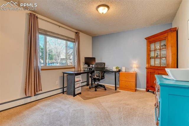 carpeted office space featuring a baseboard radiator, baseboards, and a textured ceiling