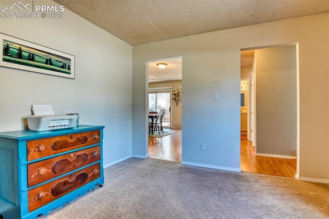 bedroom featuring carpet floors, baseboards, and a textured ceiling