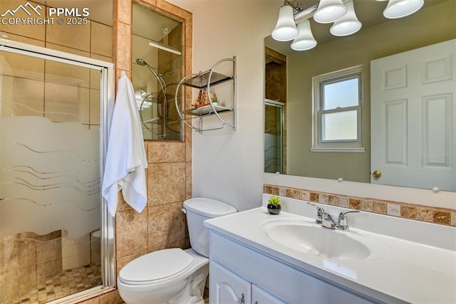 bathroom with vanity, toilet, and a shower stall