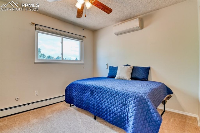 bedroom with a baseboard heating unit, carpet flooring, an AC wall unit, baseboards, and a textured ceiling