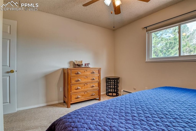 bedroom featuring baseboards, baseboard heating, carpet, and a textured ceiling