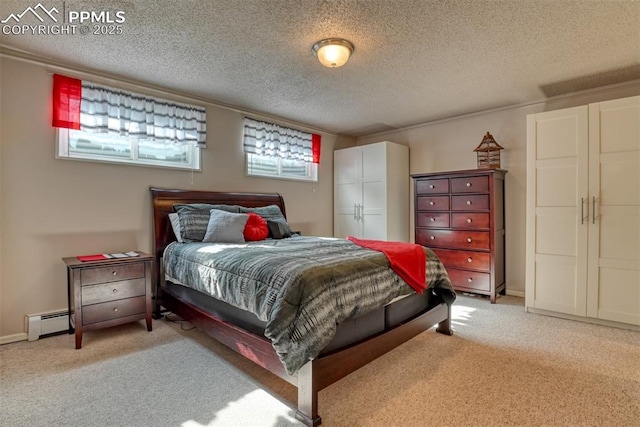 bedroom featuring light carpet, a textured ceiling, and baseboard heating