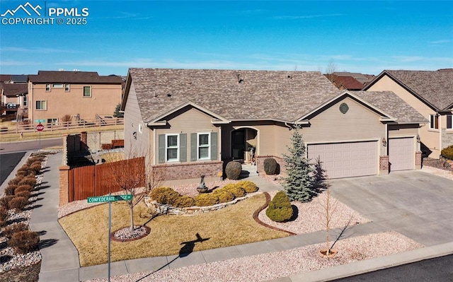 single story home with fence, driveway, brick siding, a garage, and a residential view