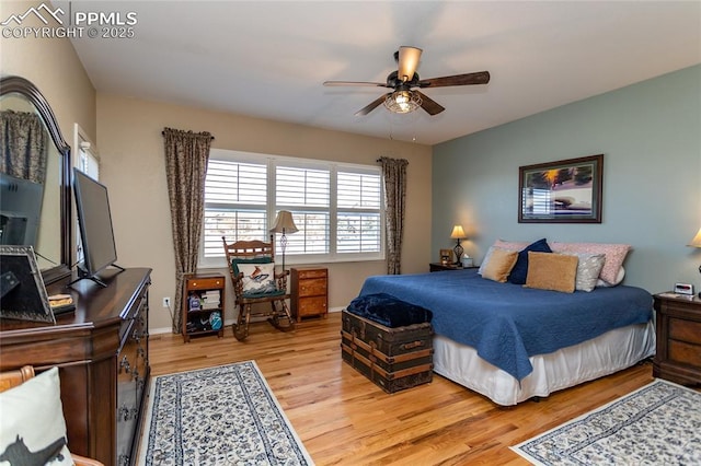 bedroom with baseboards, light wood finished floors, and ceiling fan