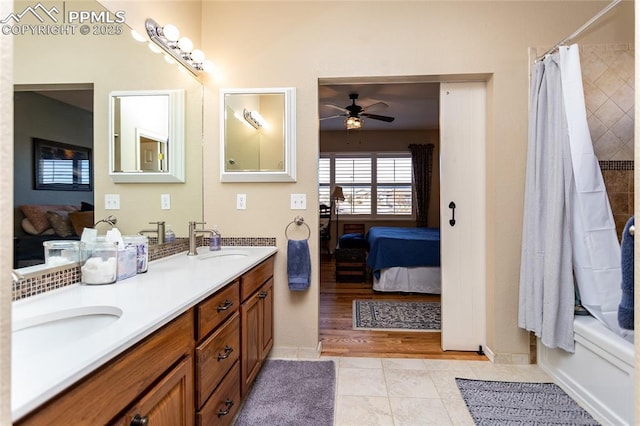 ensuite bathroom with tile patterned flooring, double vanity, ensuite bath, and a sink