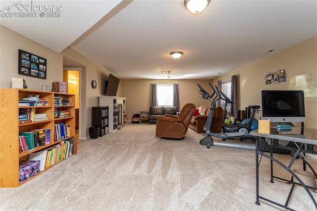 carpeted living area with a fireplace and visible vents