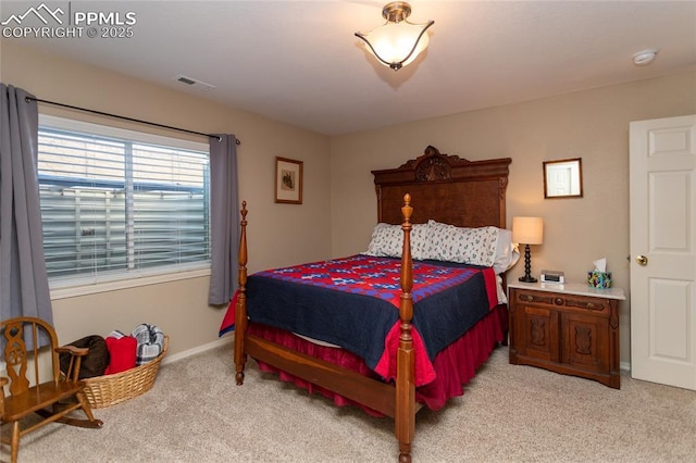 bedroom featuring visible vents, light carpet, and baseboards