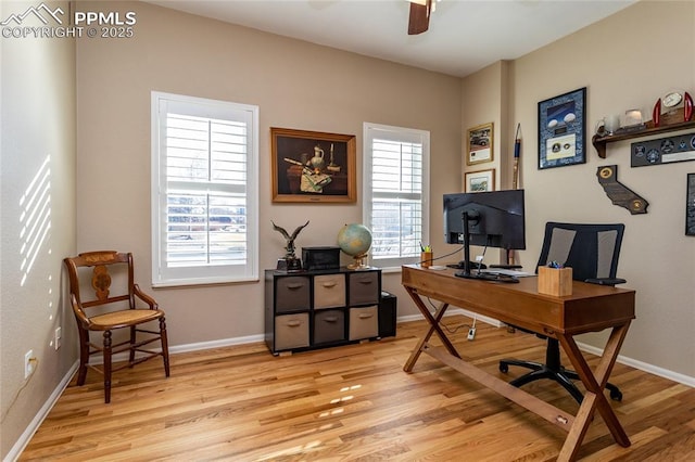 home office with light wood-style flooring, baseboards, and ceiling fan