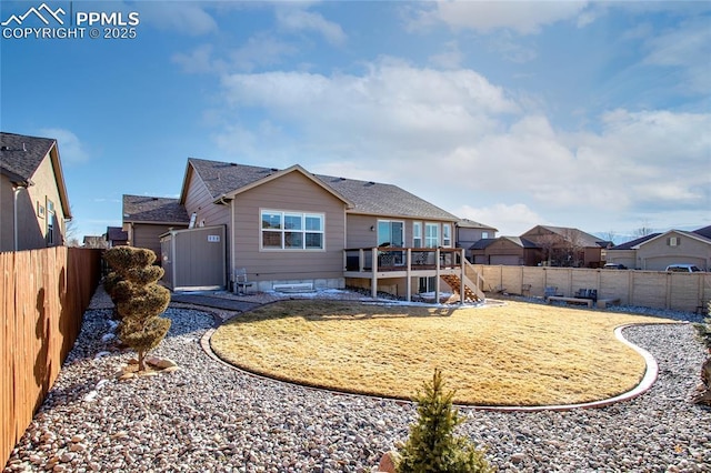 rear view of property with stairs, a fenced backyard, a lawn, and a wooden deck