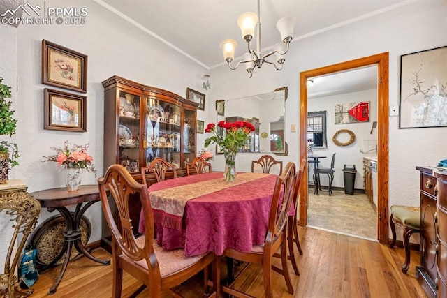 dining space featuring a notable chandelier and wood finished floors