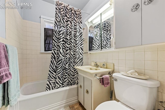 full bathroom with tile walls, toilet, decorative backsplash, shower / bath combination with curtain, and vanity