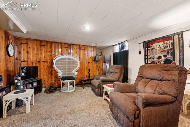 living room featuring wood walls and carpet flooring