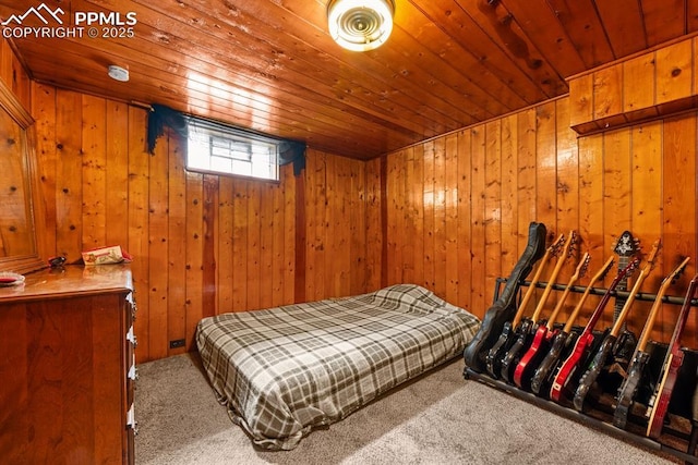 carpeted bedroom with wooden walls and wood ceiling