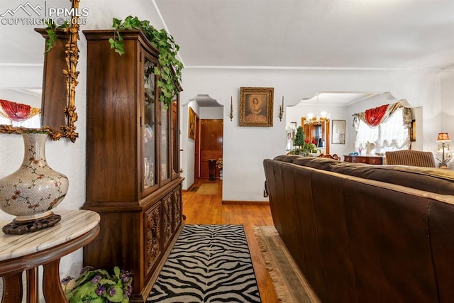 interior space featuring a notable chandelier and light wood-style flooring