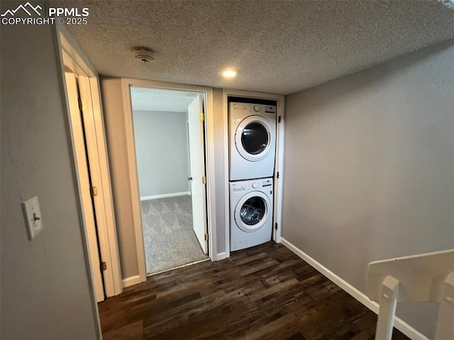 4535 Lamplighter Cir, Colorado Springs, CO 80916 - washroom with a textured ceiling, stacked washer and clothes dryer, laundry area, baseboards, and dark wood-type flooring