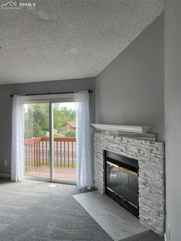 4535 Lamplighter Cir, Colorado Springs, CO 80916 - room details with carpet flooring, a fireplace, and a textured ceiling