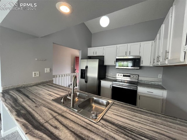 4535 Lamplighter Cir, Colorado Springs, CO 80916 - kitchen featuring white cabinetry, a sink, stainless steel appliances, and vaulted ceiling