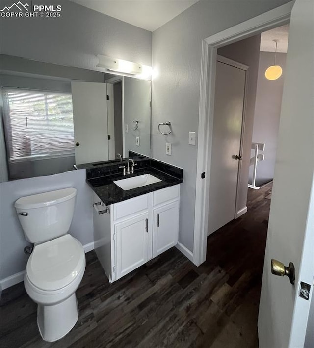 4535 Lamplighter Cir, Colorado Springs, CO 80916 - bathroom featuring toilet, vanity, baseboards, and wood finished floors