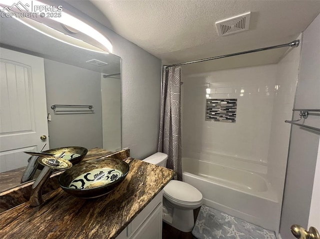 4535 Lamplighter Cir, Colorado Springs, CO 80916 - full bathroom featuring toilet, shower / tub combo with curtain, vanity, a textured ceiling, and visible vents
