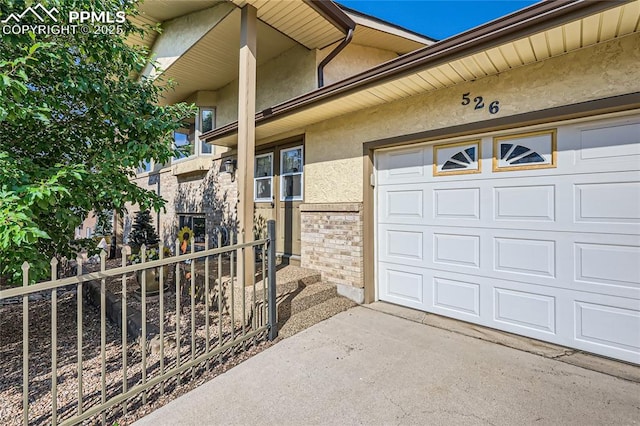 property entrance with stucco siding and a garage