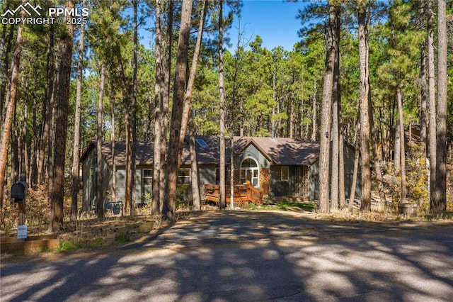 chalet / cabin featuring a wooded view