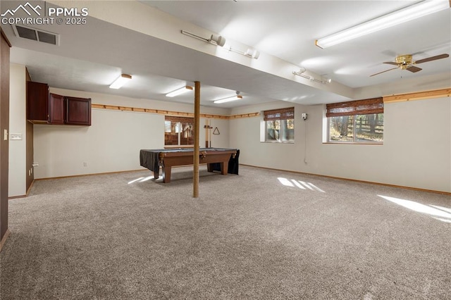 interior space featuring visible vents, light colored carpet, a ceiling fan, and baseboards