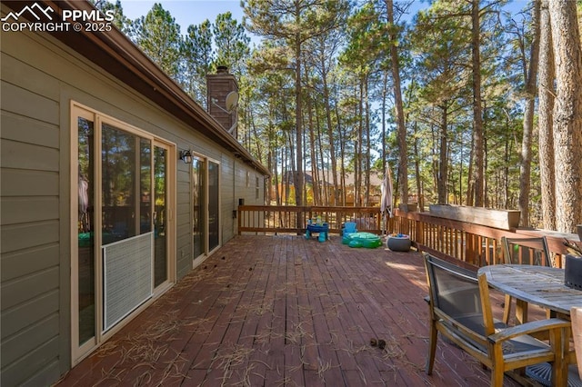 wooden terrace featuring outdoor dining space