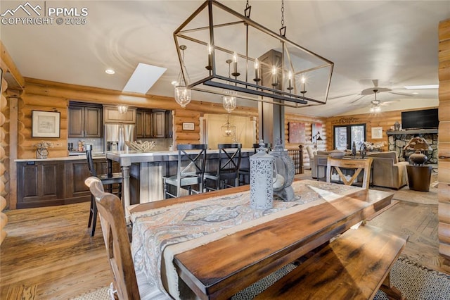 dining room with rustic walls, recessed lighting, light wood-style flooring, and a ceiling fan