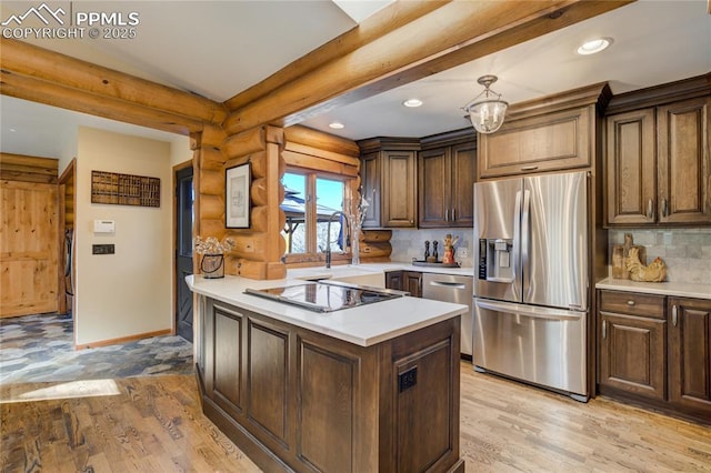 kitchen with rustic walls, light countertops, light wood finished floors, and stainless steel appliances