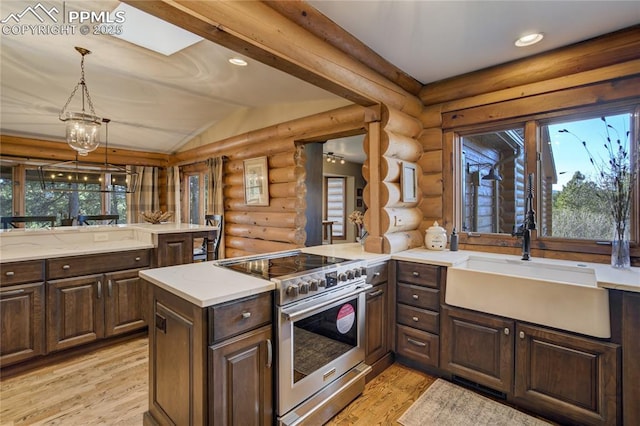 kitchen with lofted ceiling, light wood-style flooring, a sink, stainless steel range with electric stovetop, and rustic walls