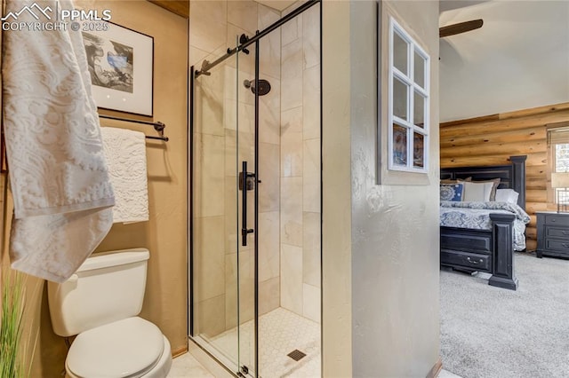 bathroom with rustic walls, ensuite bathroom, toilet, and a shower stall