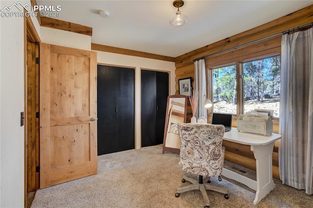 office area with carpet floors and rustic walls