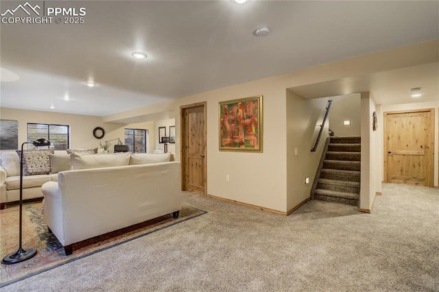 carpeted living room with stairway and baseboards